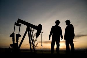 People in oil field and gas