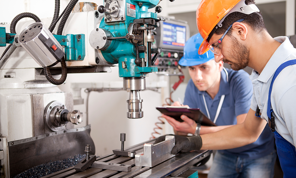 Two men working in a manufacturing factory in need of accounts receivable financing.